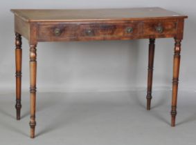 A mid-Victorian mahogany side table, the crossbanded top above three oak-lined drawers, on turned