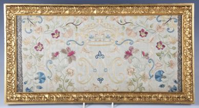 An 18th century silkwork panel, finely worked with initials below a crown, flanked by stylized