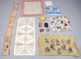 A mixed group of textiles, including silk ribbons, a gilt thread embroidered silk panel and a