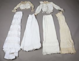 A group of Victorian and Edwardian ladies' clothing, including petticoats and bodices, one with