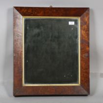 An early Victorian pollard oak framed rectangular wall mirror with a bevelled glass and gilt slip,