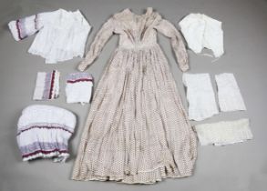 Two early Victorian printed muslin crinoline dresses, one decorated with overall red dots, the other