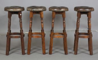 A set of four late 20th century oak framed bar stools with buttoned leather seats, height 75cm,