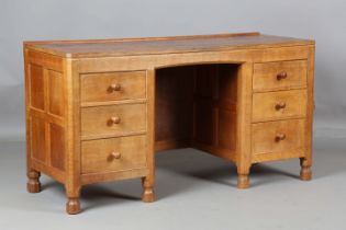 A mid-20th century Robert 'Mouseman' Thompson oak dressing table, the adzed top above six drawers