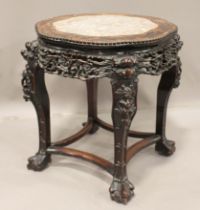 A Chinese hardwood stand, late Qing dynasty, the lobed circular top inset with a rouge marble