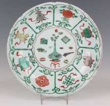 A Chinese famille verte porcelain circular dish, Kangxi period, the centre painted with a bottle