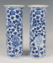 A pair of Chinese blue and white porcelain cylinder vases, mark of Kangxi but late 19th century,