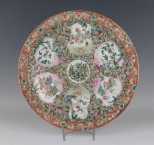 A Chinese Canton porcelain circular dish, mid to late 19th century, painted with a central flower