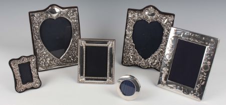 An Elizabeth II silver mounted rectangular photograph frame with heart shaped aperture, embossed