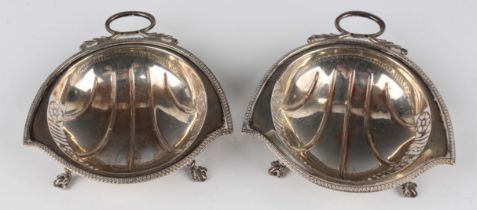 A pair of George V silver shaped circular bonbon dishes, each rim with pierced decoration flanked by