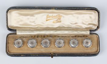 A set of six gold backed and mother-of-pearl dress buttons, each with a wirework centre and