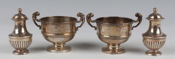 A pair of George V silver salts, each in the form of a two-handled trophy cup, Chester 1912 and 1914