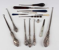 Two late Victorian silver handled buttonhooks, one decorated with amorini, Chester 1897, the other