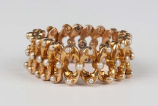 A gold and half-pearl bracelet in an expanding design, detailed '15', weight 16.5g, fully extended