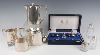 An Elizabeth II silver three-piece condiment set of oval form on scroll legs, comprising mustard,