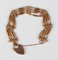 A gold decorated and plain multiple link gate bracelet, detailed '9c', on a gold heart shaped