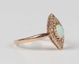 A gold, opal and diamond marquise shaped cluster ring, claw set with the oval opal within a surround