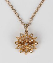 An Edwardian gold and seed pearl pendant, designed as a starburst, detailed '15ct', weight 4.3g,