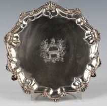 A George III silver circular card salver, crest engraved within a raised scallop shell and scroll