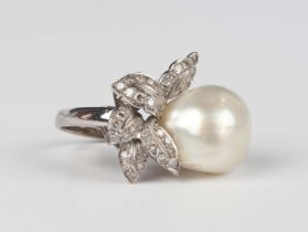 A white gold, diamond and blister pearl ring in a foliate design, mounted with the large blister