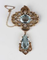 A Victorian gold and aquamarine pendant brooch, the top mounted with an oval cut aquamarine in a