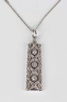 A diamond pendant of tapered rectangular form, claw set with three cushion cut diamonds, otherwise