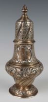 An Edwardian silver baluster sugar caster with spiral foliate and reeded scroll decoration, on a