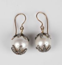 A pair of silver mounted, cultured pearl and diamond earrings, each mounted with a single cultured