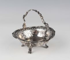 A George II silver circular bonbon basket with pierced and entwined swing handle above pierced