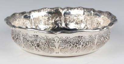 An early Victorian silver bowl of shallow circular form, the lobed sides decorated in relief with