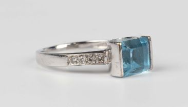 A white gold, aquamarine and diamond ring, claw set with the cut cornered rectangular step cut