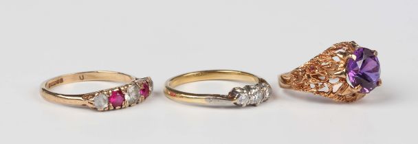 A gold and diamond three stone ring, mounted with a row of circular cut diamonds, unmarked, weight