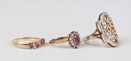 A 9ct gold ring, mounted with four rectangular cut rubies alternating with three pairs of circular