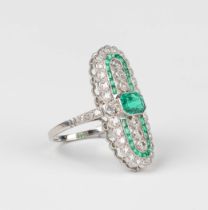 A platinum, emerald and diamond panel shaped ring, collet set with the principal cut cornered