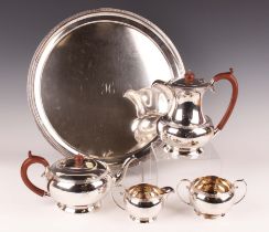 A George V silver five-piece tea set of squat circular form, cast with bands of foliate scrolls,