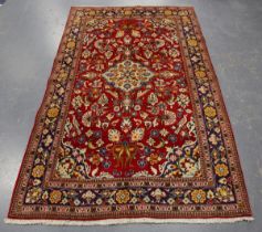 A Sarough rug, Central Persia, late 20th century, the red field with a shaped ivory medallion