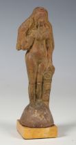 An ancient Roman terracotta full-length figure of a lady with long flowing hair, standing beside a