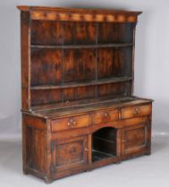 An 18th century provincial oak dresser, the plate rack above an arrangement of drawers and