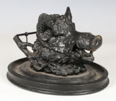 A late 19th century black painted cast spelter novelty inkwell in the form of a boar's head, mounted