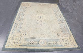 An Aubusson style carpet, mid-20th century, the pale green field with a foliate medallion, within