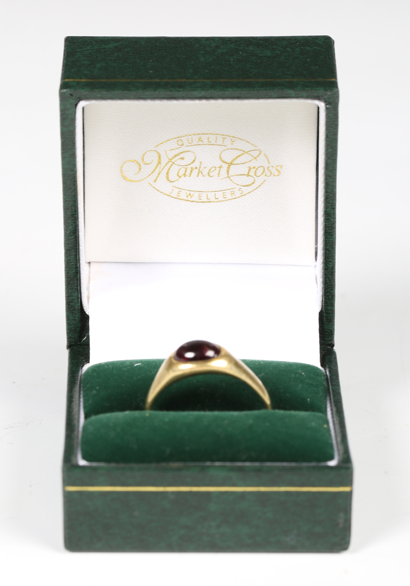 A medieval gold and garnet cabochon set ring, the garnet probably a later replacement, diameter 2cm. - Image 2 of 6