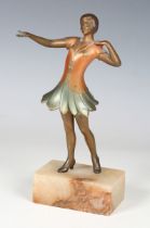 An Art Deco cold painted cast spelter figure of a dancer, raised on an alabaster pedestal, height