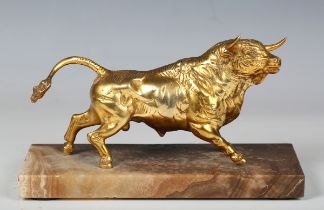 A 20th century cast gilt metal model of a bull, raised on a hardstone base, width 24cm.Buyer’s