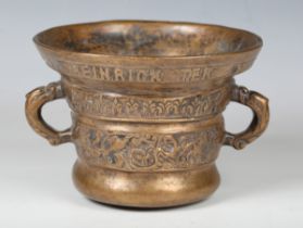 A 17th century style cast bronze mortar, decorated with bands of script and foliage, the sides