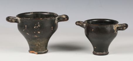 An ancient Greek black glazed skyphos, circa 6th century BC, modelled with flattened twin handles,