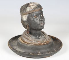 A late 19th century cold painted cast spelter novelty inkwell, in the form of the head of a black