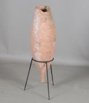 A large Roman sea-found amphora, modelled with a elongated ovoid body, height 84cm, mounted on a