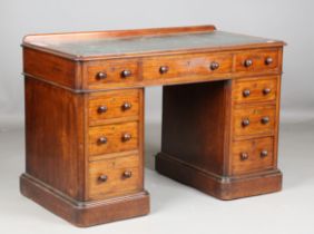 A mid-Victorian mahogany twin pedestal desk, the moulded edge top inset with tooled green leather