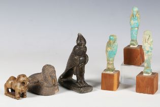 A group of Egyptian antiquities, including three turquoise faience ushabti, height 7.5cm (faults), a