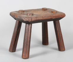 A 19th century provincial ash hearth stool with four staked legs, height 17cm, width 20cm.Buyer’s